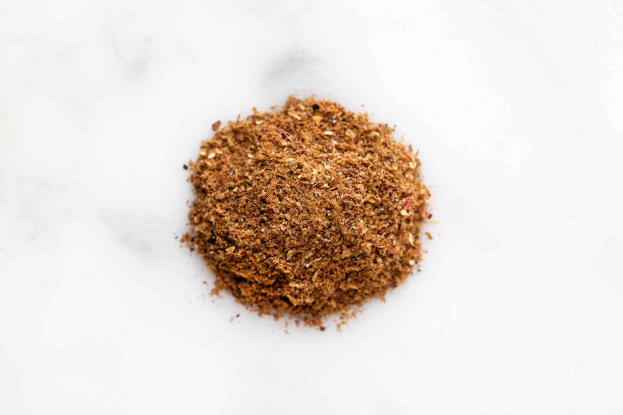 Mound of ground advieh spice blend in a loose pile