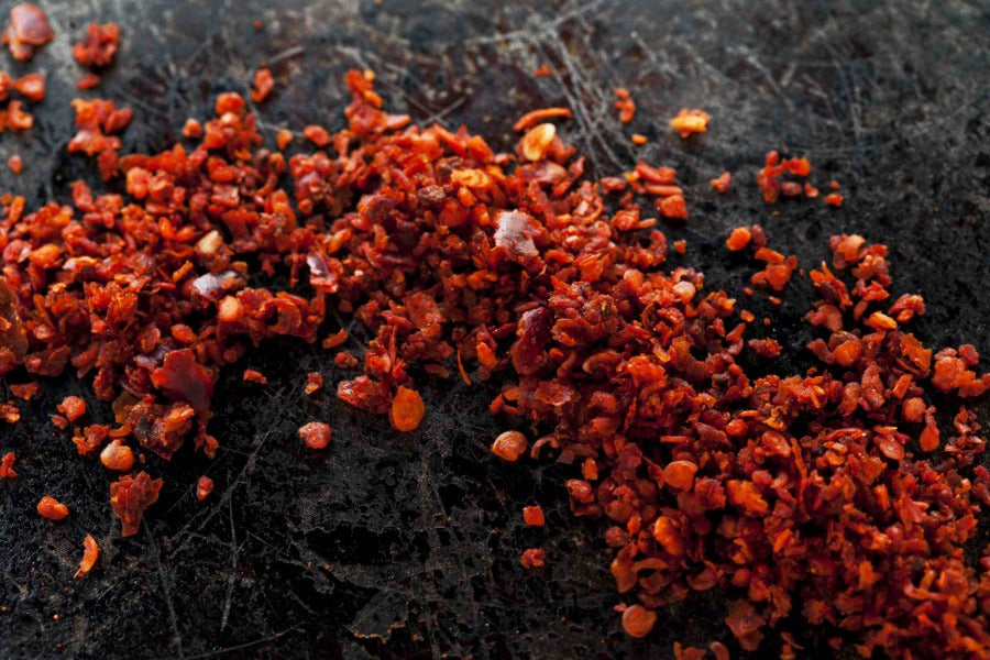Aleppo pepper flakes, red chili pepper bits in a loose pile