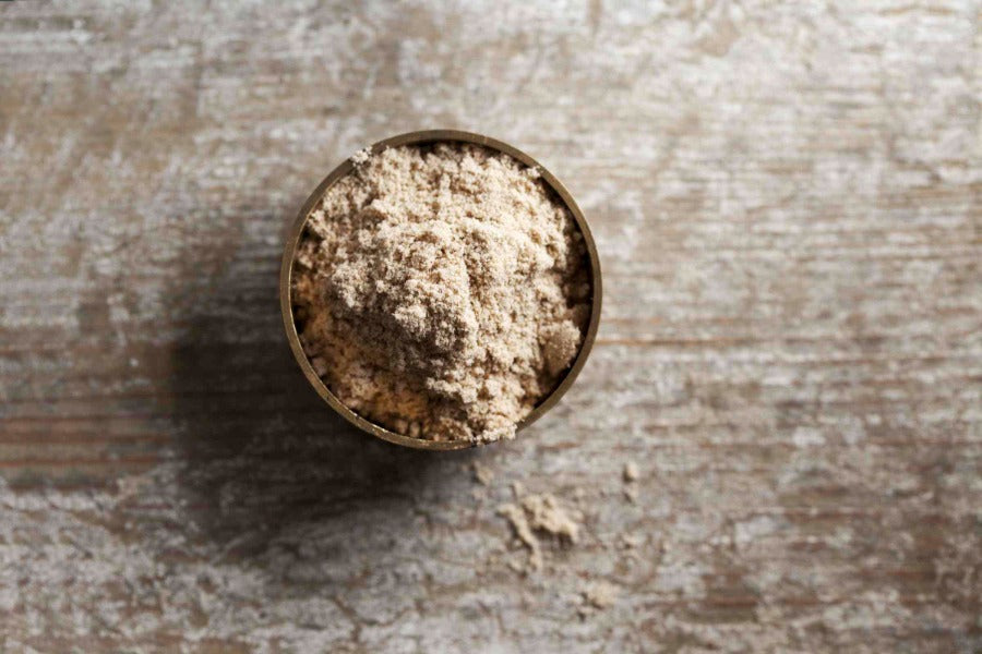 Amchoor mango powder in a small bowl, light beige fine powder