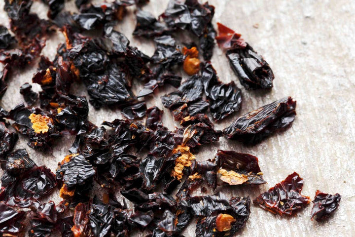 Ancho chili flakes of dark crinkled chile pieces with small reddish-brown bits