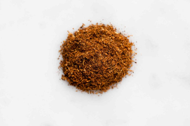 Ground spice powder mound in dark brown