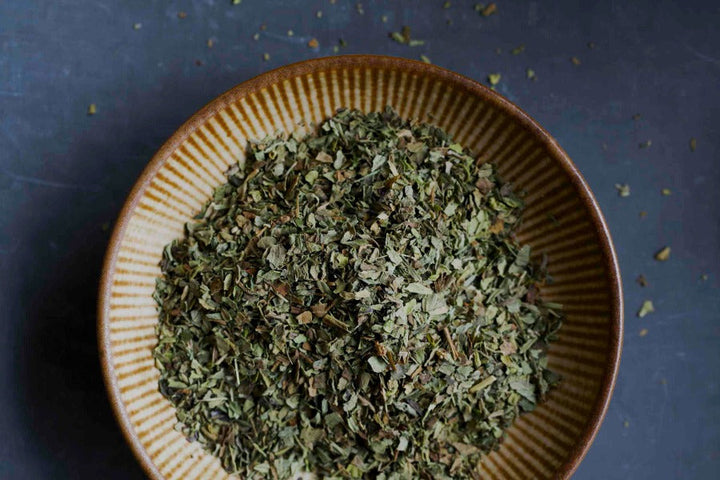 Bowl of chopped dried basil herb
