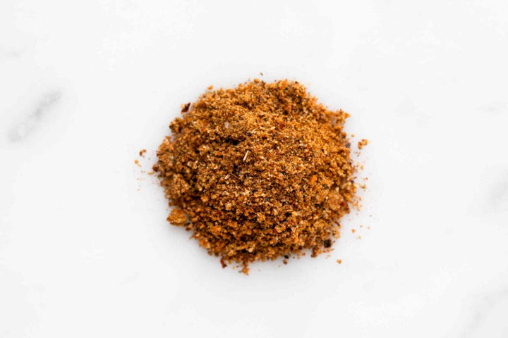Ground BBQ rub seasoning, finely mixed spice heap in a circular pile