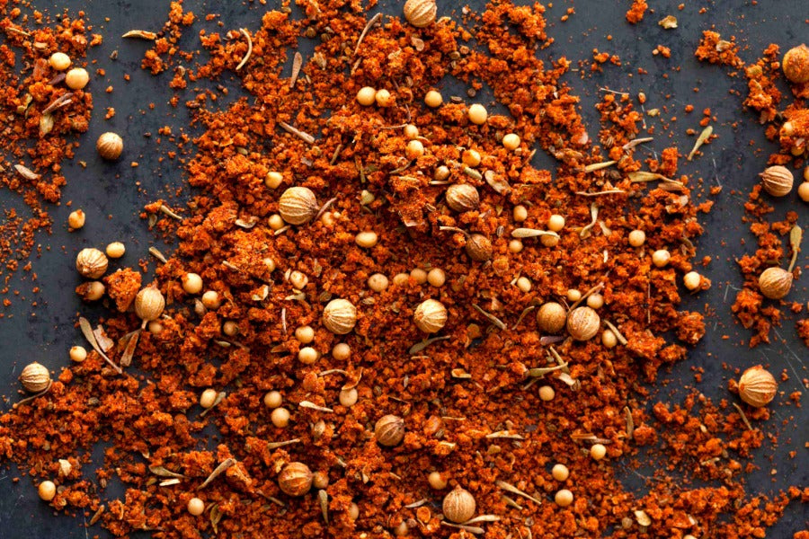 BBQ rub spice blend with red-orange granules and dried herb bits