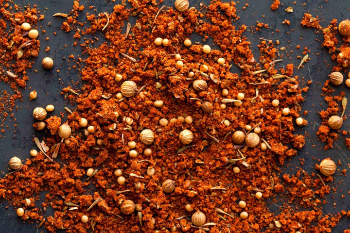 BBQ rub spice blend with red-orange granules and dried herb bits