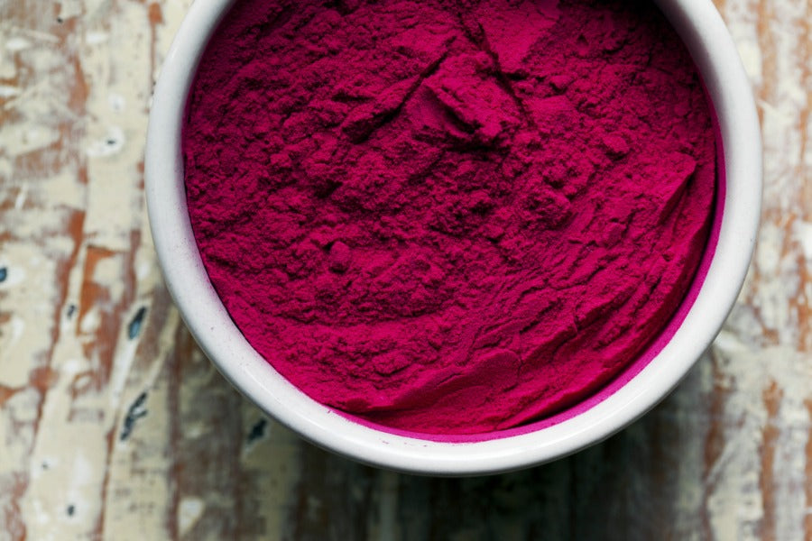 Beet powder: deep magenta fine powder in white bowl