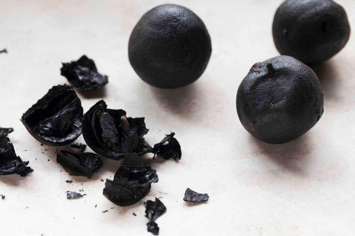 Preserved black lemon whole fruit with small broken pieces