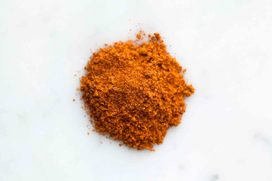 Caribbean spice blend pile of fine orange-brown ground seasoning