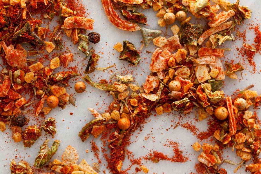 Pile of red-brown Creole-style spice seasoning with speckled herb flakes