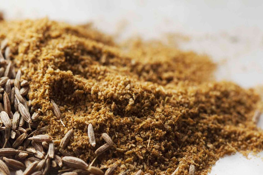 Ground cumin powder with a few whole cumin seeds