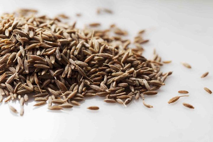 Whole cumin seeds, brown elongated grains