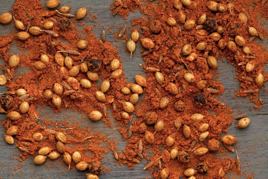 Red-orange curry spice blend with whole seeds