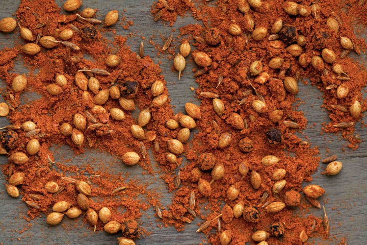 Red-orange curry spice blend with whole seeds