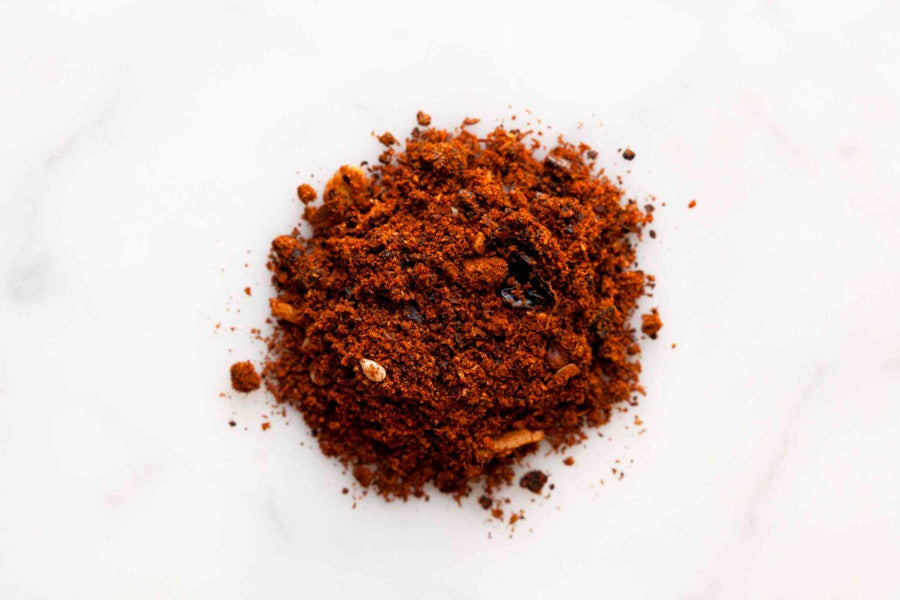 Dark ground mole seasoning spice pile in a circular mound