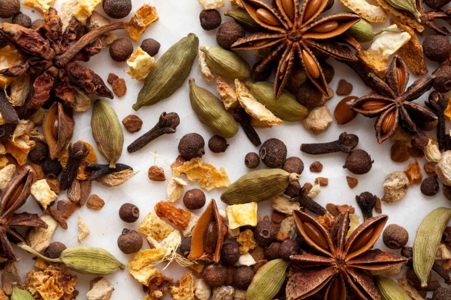 Assorted mulling spices with star anise, cinnamon pieces, orange peel, and cloves