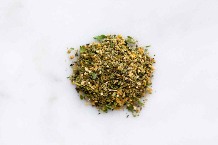 Finely chopped dried orange tarragon herb blend mound