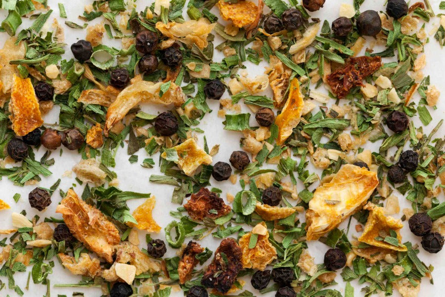 Dried herb blend with green leaves and small orange pieces