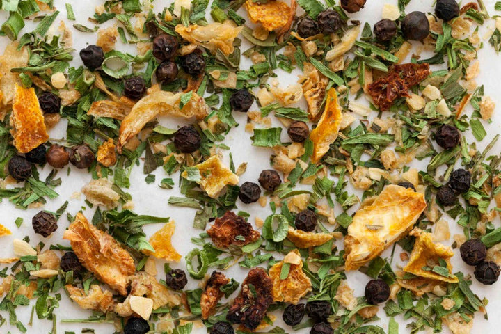 Dried herb blend with green leaves and small orange pieces