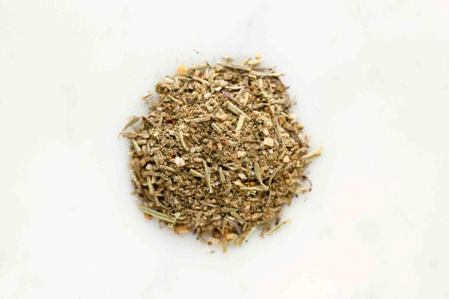 Poultry seasoning rub blend, loose chopped herbs and spices in a pile