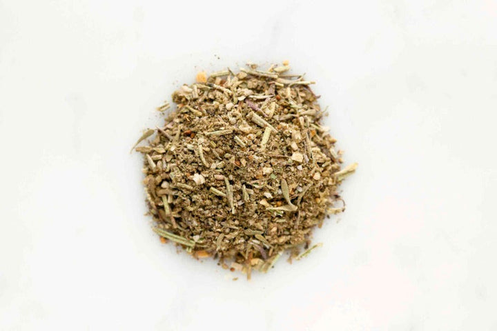 Poultry seasoning rub blend, loose chopped herbs and spices in a pile