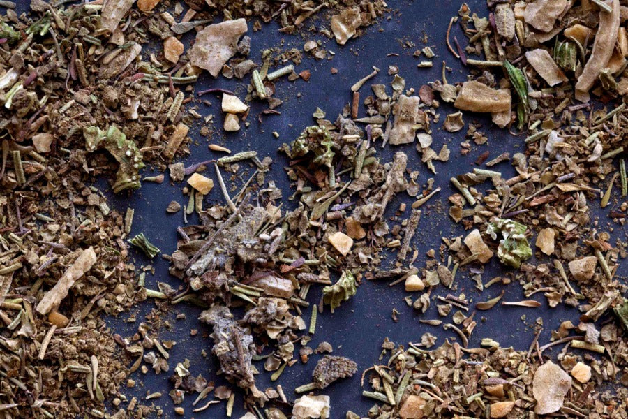Poultry seasoning rub with chopped herbs and spices, scattered