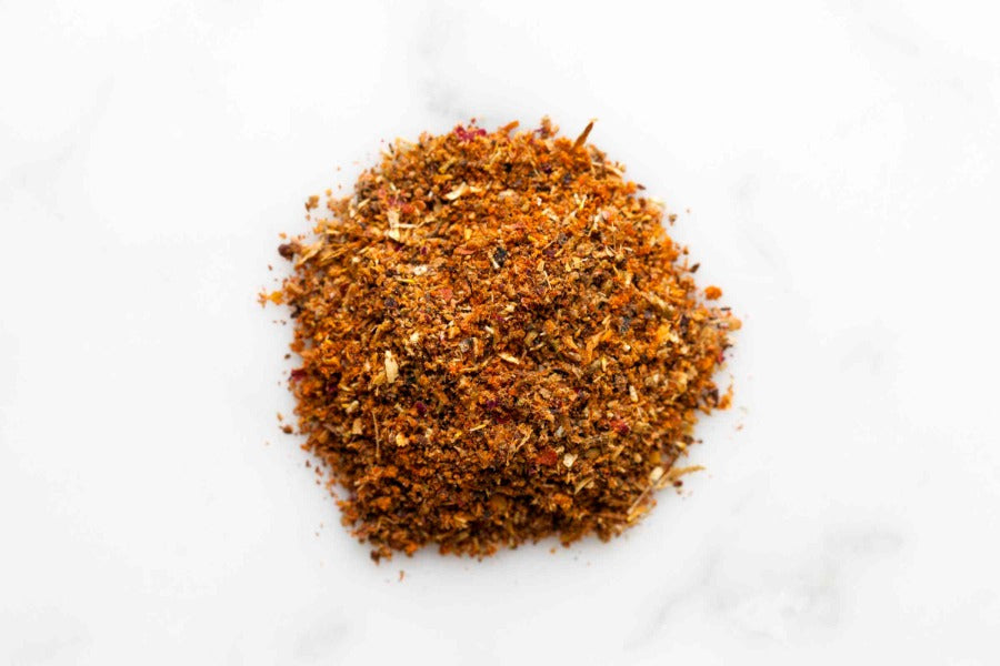 Ground spice powder pile, fine orange-brown texture in a round mound