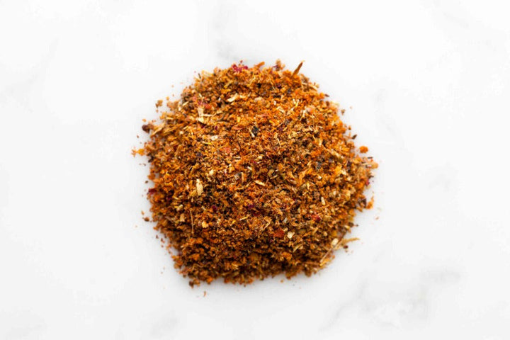 Ground spice powder pile, fine orange-brown texture in a round mound