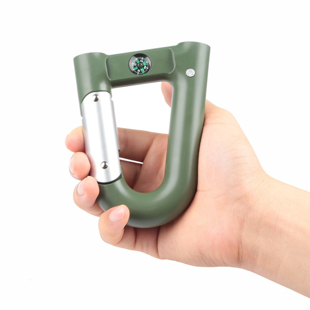 Green carabiner power bank in hand showing silver flashlight module and compass dial