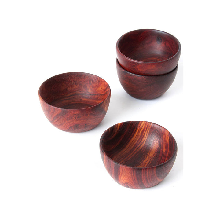 Small teak bowl set in reddish-brown, three views showing carved wood grain