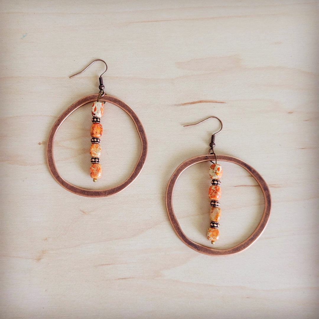 Copper hoop earrings with orange bead-and-copper dangle, hook backs.