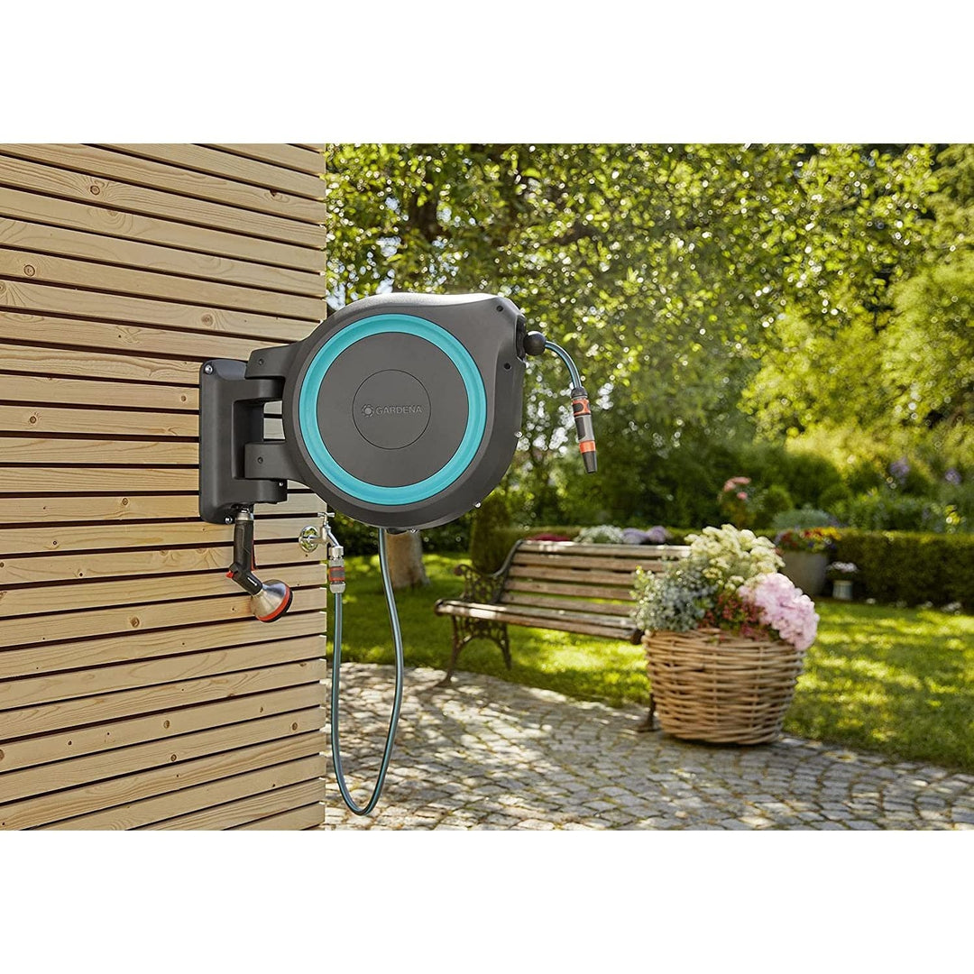 Wall-mounted hose reel mounted on wood siding with blue ring and connected hose