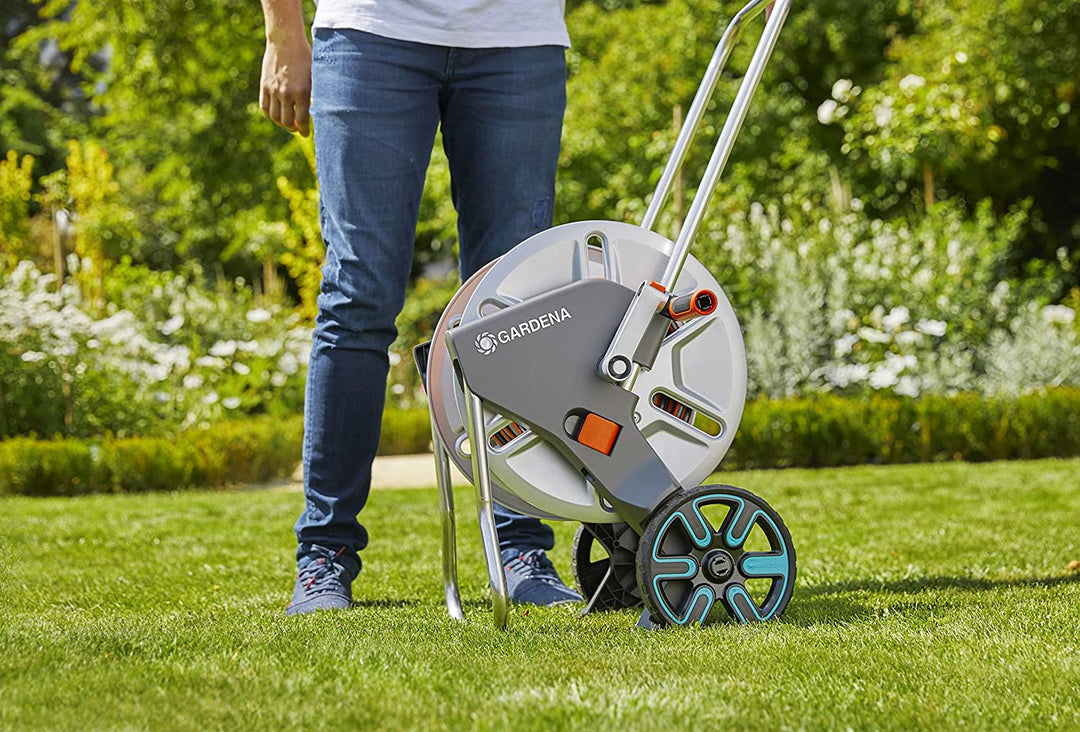 Metal hose reel cart with gray drum and orange hose on two-wheel stand