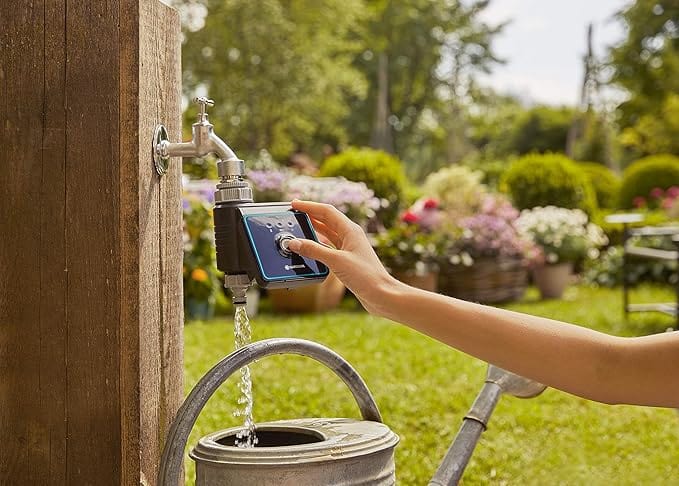 Bluetooth water control controller mounted on outdoor faucet, smartphone in hand