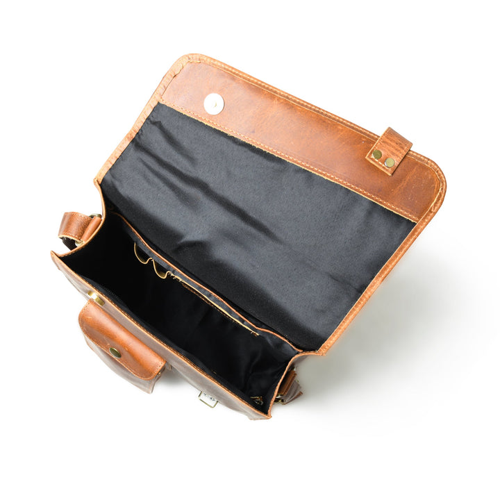 Brown leather crossbody bag interior with black lining and front zip pocket