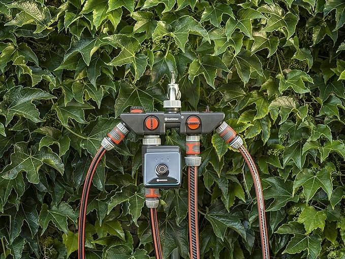 Bluetooth water control manifold with screen and orange dials, connected valves