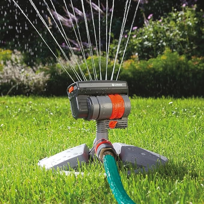 Oscillating sprinkler on weighted sled base with orange dial and hose connector