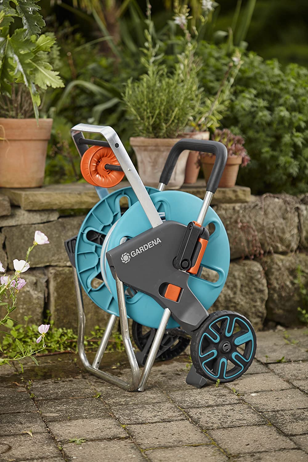 Hose trolley with blue reel, orange hose spool, black cart and blue wheel
