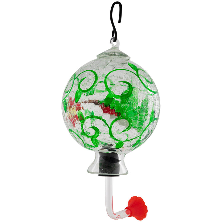 Hand-painted glass hummingbird feeder with green swirls and red flower accents