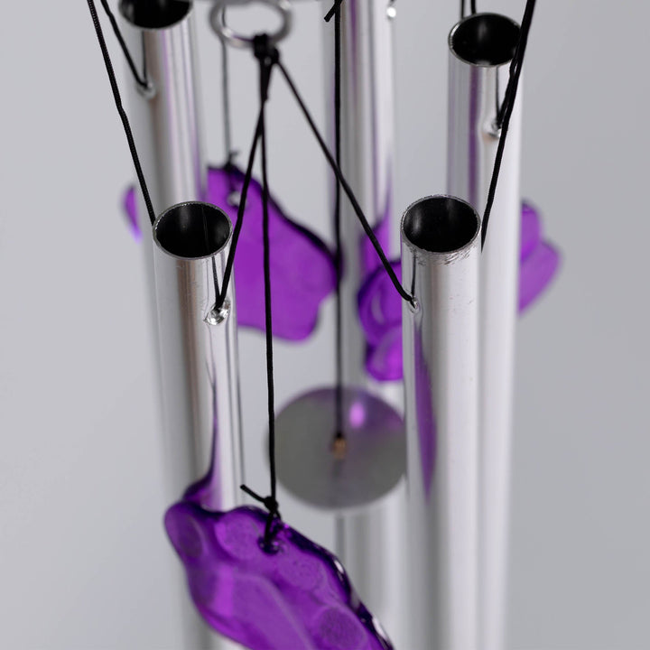Pet memorial wind chime close-up: purple hanging charms on silver tubes