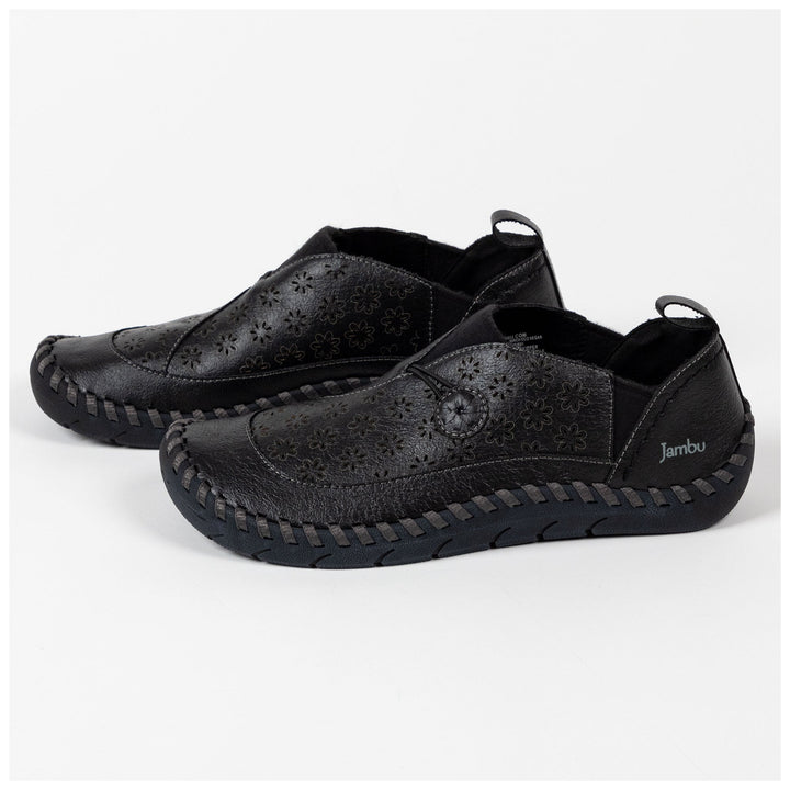 Black vegan loafer slip-ons with floral perforated uppers and cushioned platform sole