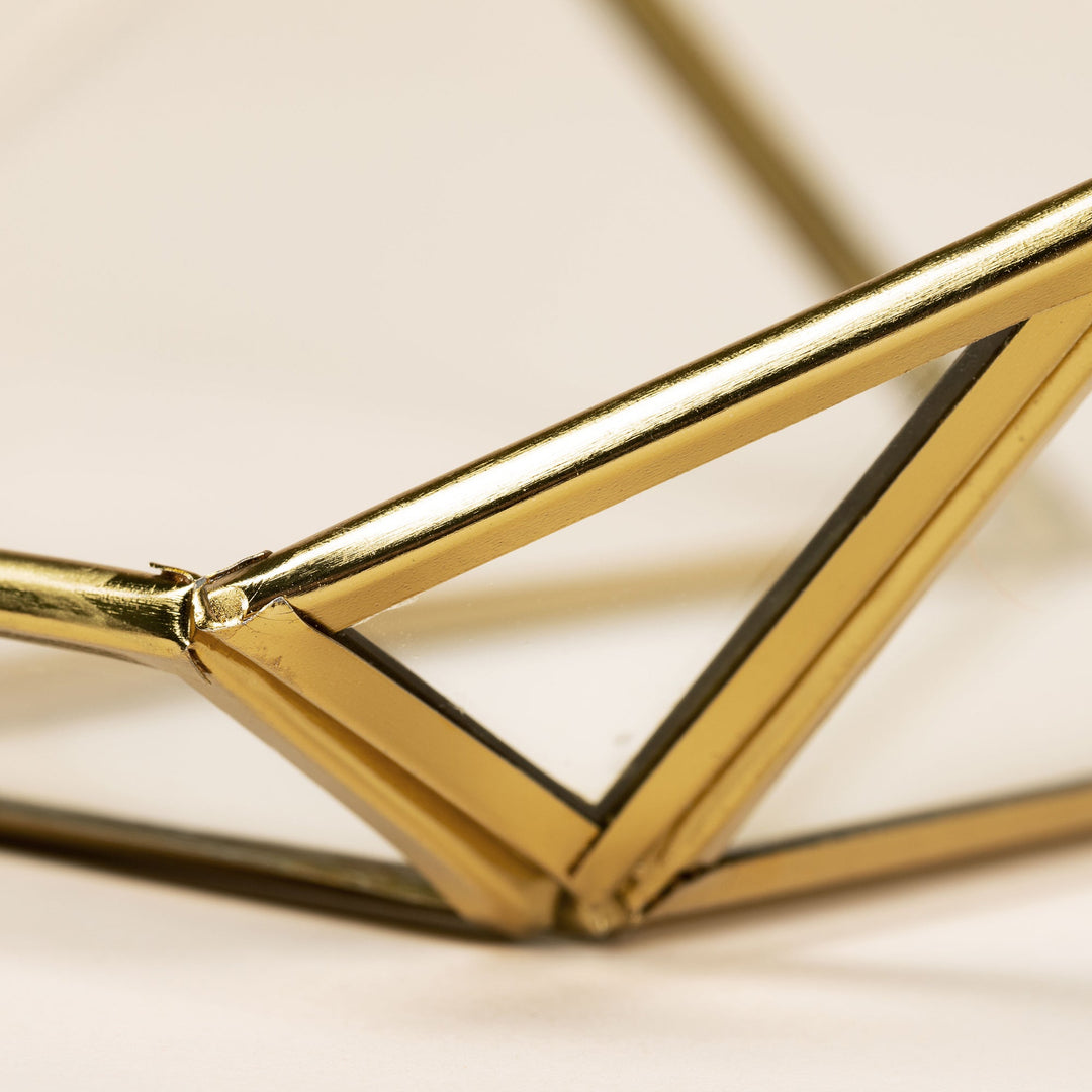 Close-up of gold metal frame joint on a hanging glass bird feeder