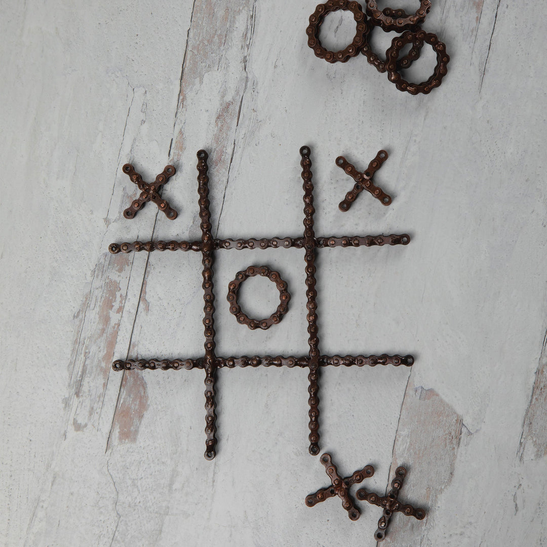 Recycled chain-link tic-tac-toe board layout with X crosses and O rings in a grid.