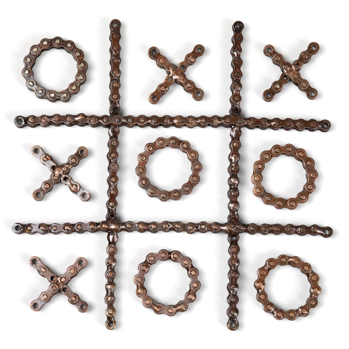 Recycled chain-link tic-tac-toe game pieces arranged in a 3x3 grid with X and O.