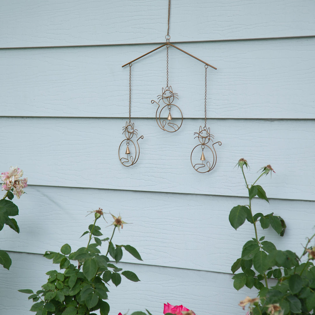 Outdoor-ready iron wind chime with cat silhouettes and hanging bells