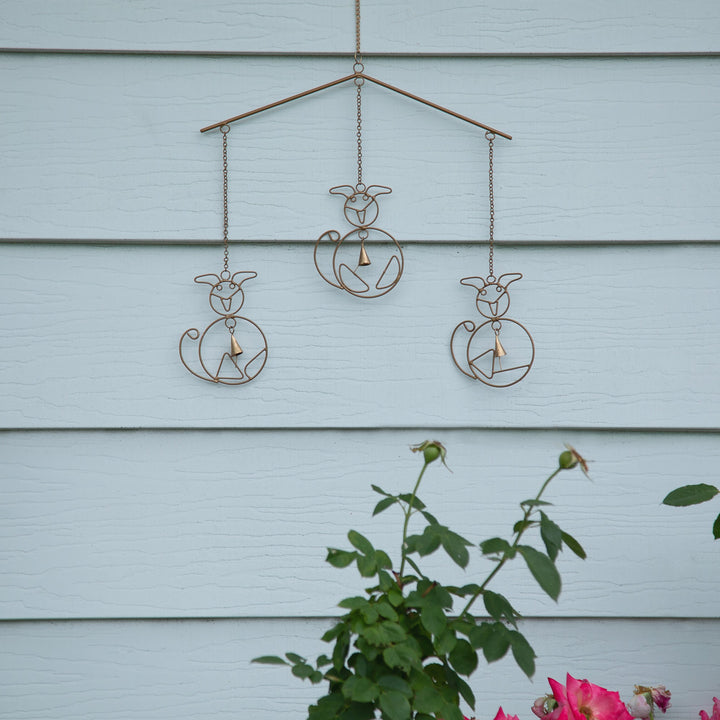 Iron wind chime with four cat silhouettes, hanging chains, and bell clappers