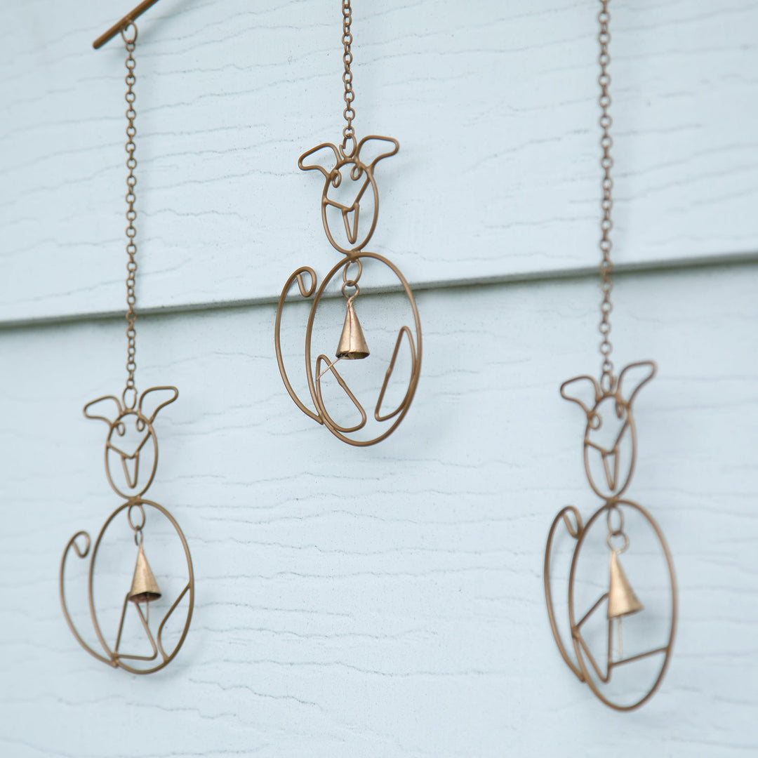 Iron wind chime showing three cat silhouettes and hanging bell clappers