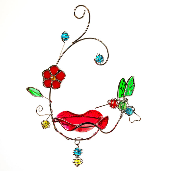 Stained glass hummingbird feeder ornament with red bird body, green wing panel, and flower detail.