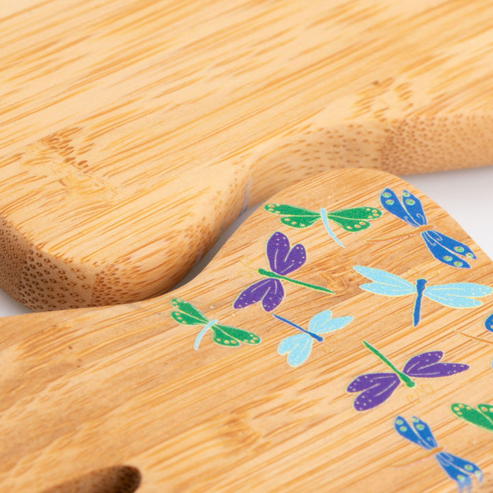 Bamboo bear claw serving utensil close-up with dragonfly and leaf design