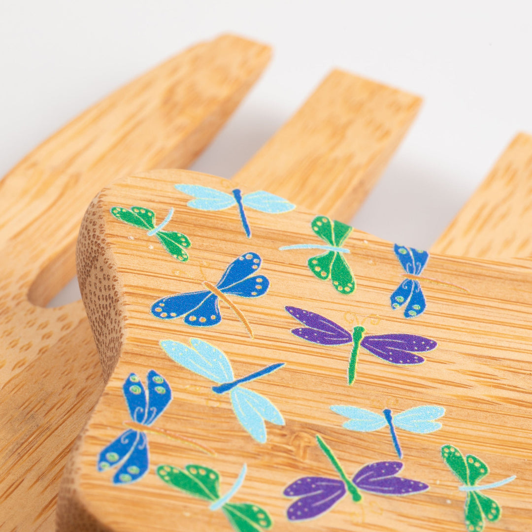Bamboo bear claw serving utensil close-up with colorful dragonfly vine pattern