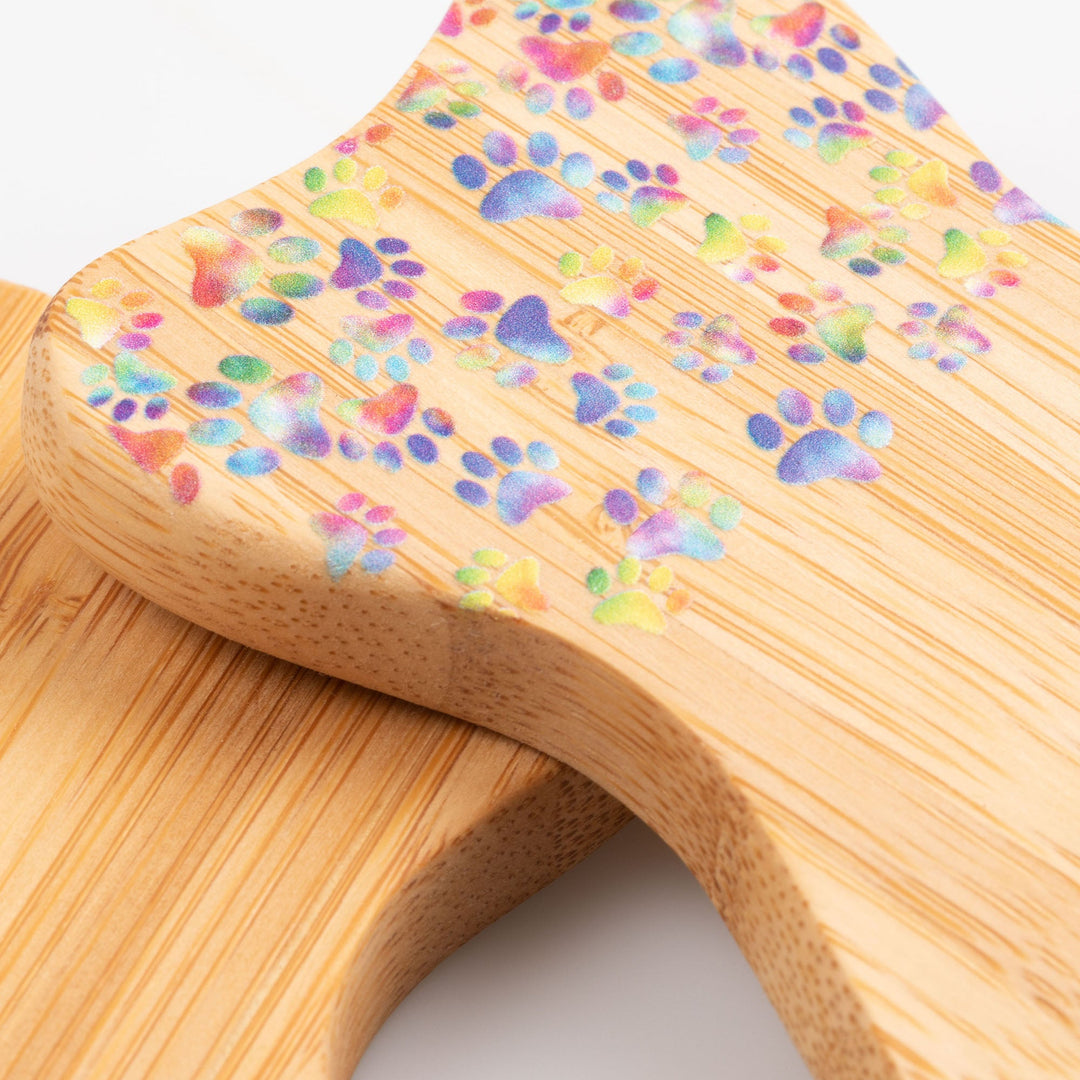 Bamboo bear claw serving utensil close-up with multicolor paw and heart pattern